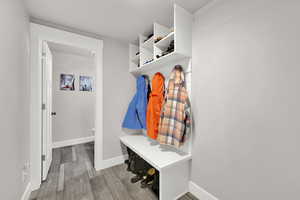 Mudroom with baseboards and wood finished floors