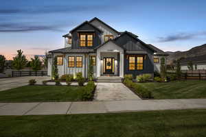 Modern farmhouse featuring board and batten siding, a standing seam roof, a metal roof, and concrete driveway