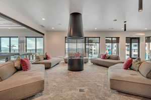 Living area featuring healthy amount of natural light, recessed lighting, and carpet floors