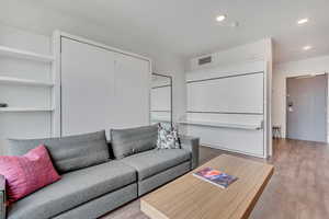 Living room featuring wood finished floors and recessed lighting