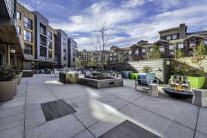View of patio with an outdoor fire pit and a residential view