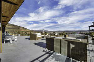View of patio featuring outdoor lounge area and a mountain view