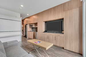 Living area featuring wood finished floors and recessed lighting