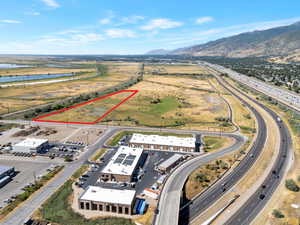 Aerial view of property's location with a water and mountain view and property parcel outlined