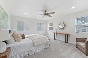 Bedroom with light colored carpet, recessed lighting, and a ceiling fan