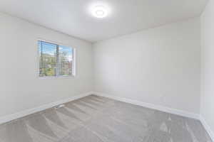 Spare room featuring light colored carpet