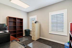 Office area featuring carpet floors and baseboards