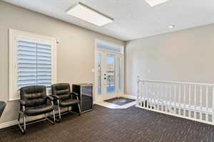 Community lobby featuring a textured ceiling and recessed lighting