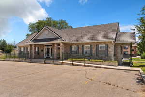 View of front of home featuring uncovered parking and brick siding