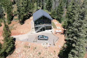 Aerial view of property and surrounding area featuring a heavily wooded area