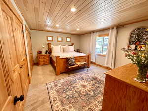 Bedroom featuring recessed lighting, wooden ceiling, light carpet, and ornamental molding