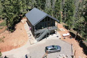 Aerial view of property and surrounding area featuring a heavily wooded area