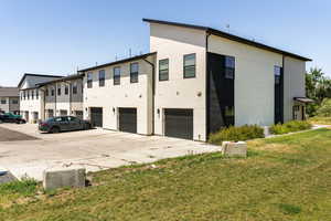 View of property with an attached garage and driveway