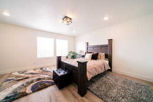 Bedroom with light wood-type flooring and recessed lighting