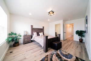Bedroom with light wood-type flooring and recessed lighting