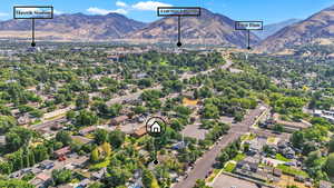 Aerial view of property's location with nearby suburban area and a mountainous background