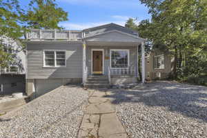 View of front of home featuring a porch, an attached garage, and driveway