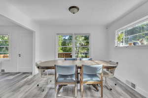Dining area featuring ornamental molding and wood finished floors