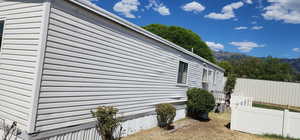 View of side of home featuring a mountain view