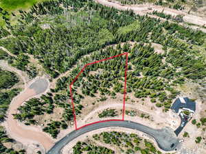 Aerial view of sparsely populated area with property parcel outlined