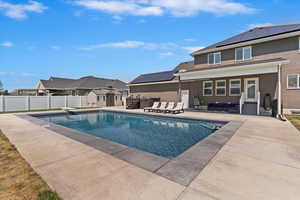 View of swimming pool with a patio, a shed, outdoor lounge area, and a diving board