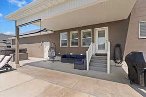 View of patio / terrace featuring a hot tub, area for grilling, entry steps, and outdoor lounge area