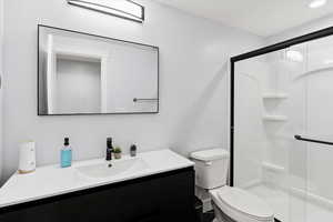 Bathroom featuring vanity and a stall shower
