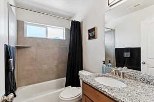 Full bath featuring shower / tub combo and vanity