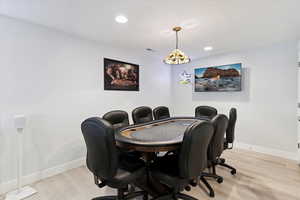 Office area with recessed lighting and light wood-style flooring