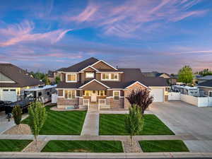 View of front of property with driveway, a garage, and stone siding