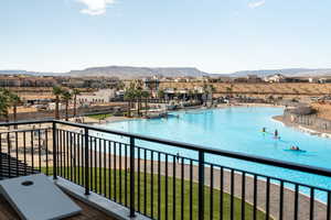 Balcony featuring a mountain view and view of pool area