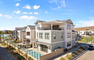 Back of property with a residential view, a pergola, a standing seam roof, and a community pool