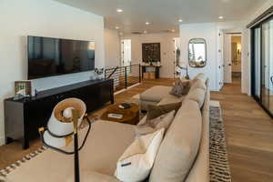 Living area with wood finished floors and recessed lighting