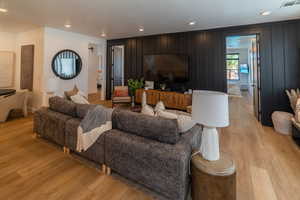 Living area with recessed lighting and light wood-style floors