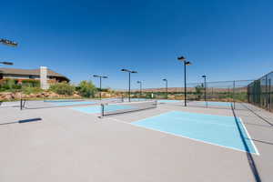 View of tennis court featuring community basketball court