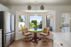 Dining space with healthy amount of natural light and light wood-style flooring