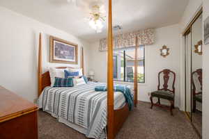 Carpeted bedroom featuring a ceiling fan