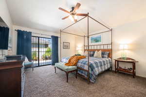 Bedroom with lofted ceiling, carpet, and ceiling fan