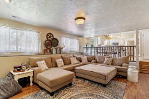 Living area featuring a textured ceiling and light wood finished floors