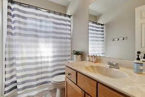 Full bath featuring vanity and a shower with curtain