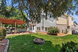 View of yard featuring a fire pit, a pergola, and a patio area