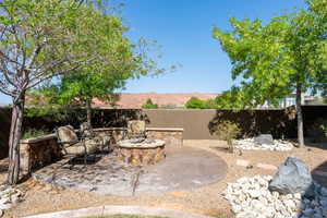 View of patio featuring an outdoor fire pit