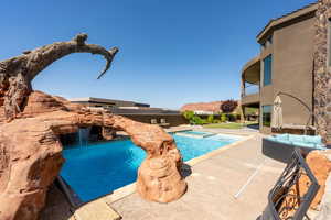 View of swimming pool featuring a patio area and a pool with connected hot tub