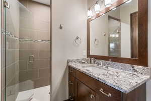 Full bath with vanity and a stall shower