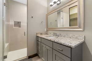 Bathroom featuring a shower stall and vanity