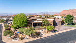View of front of house featuring a residential view, driveway, and a mountain view