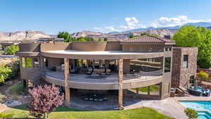 Exterior space featuring a mountain view, a patio, an outdoor pool, and an outdoor hangout area