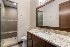 Bathroom featuring vanity, a stall shower, and tile patterned flooring