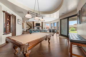Rec room with wood-type flooring, pool table, a glass covered fireplace, and recessed lighting