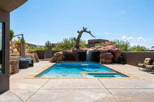 View of pool featuring a patio and a pool with connected hot tub